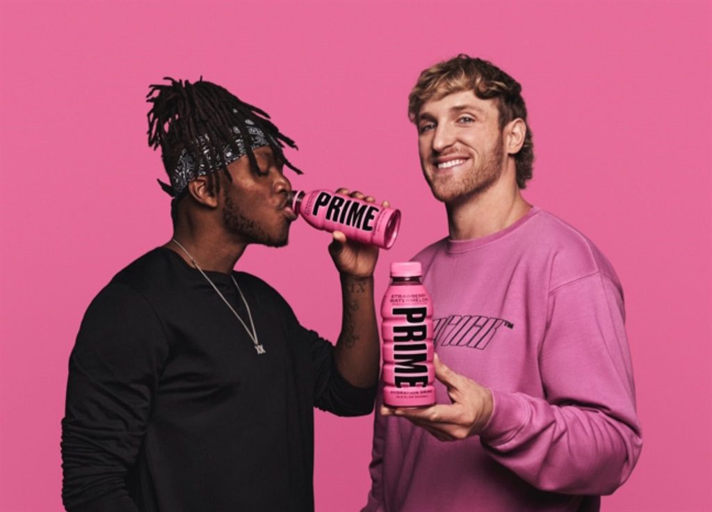 The Strategic Partnership Behind Prime Hydration's Success 1 co-founders of Prime Hydration, energetically posing with cans of their branded energy drink.