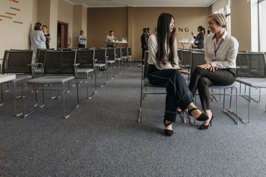 Executive Leadership Programs Emphasize Network Building Over Skills Alone for Women Advancement 1 women professionals engaged in conversation at workplace event