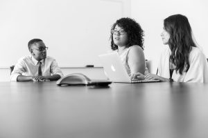 diverse women leaders discussing strategy in modern office
