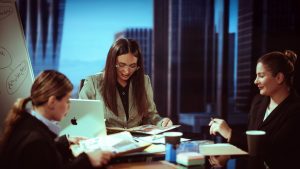Senior women leaders collaborating in modern conference room