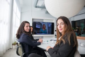 Women executives discussing business strategy in a modern office