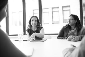 Women leaders in professional setting discussing strategy