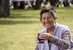 Elderly Japanese woman smiling in a garden, representing longevity and healthy aging in Japan