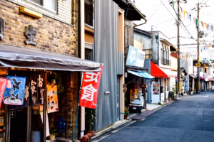 Older Japanese woman smiling in a quiet urban neighborhood