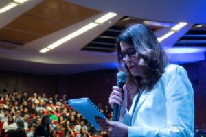 A woman professional receives recognition at a formal awards event in India