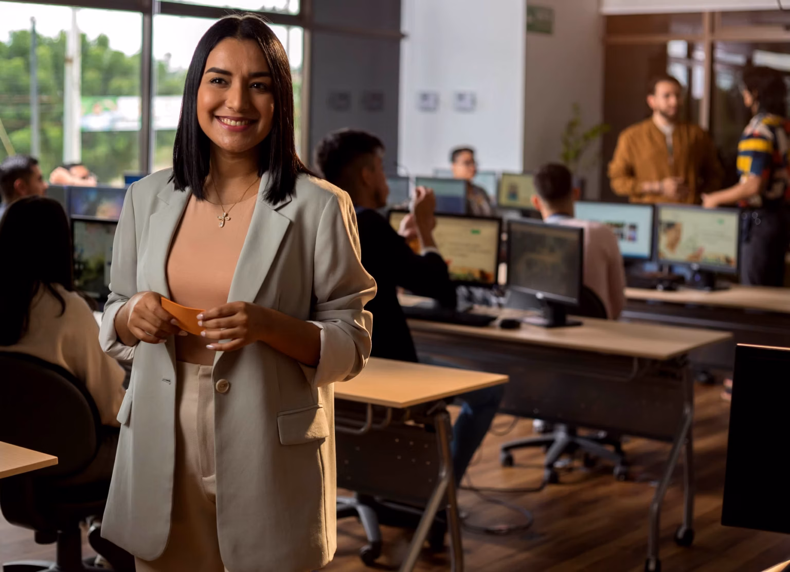 A confident female tech founder standing in a modern, light-filled office space