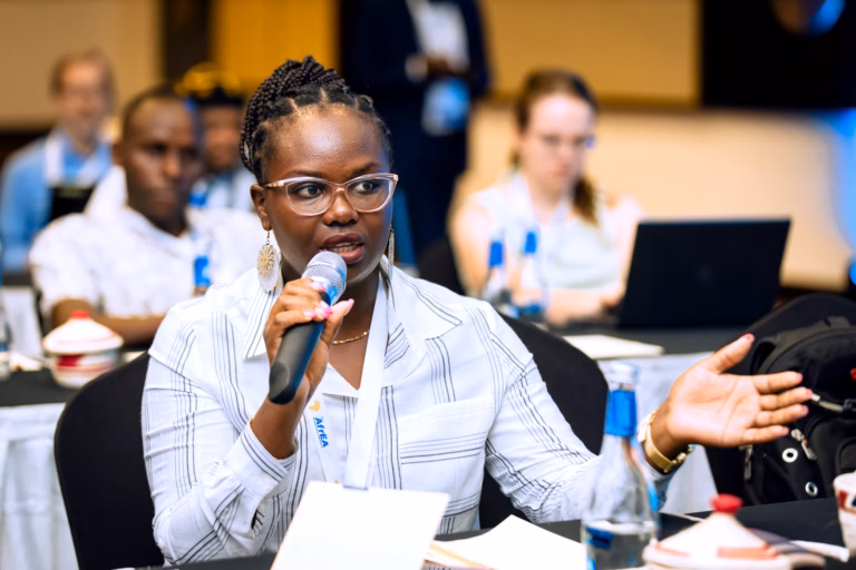 Women leaders seated at a panel discussion table at a professional conference