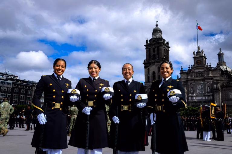 A woman military officer stands in uniform