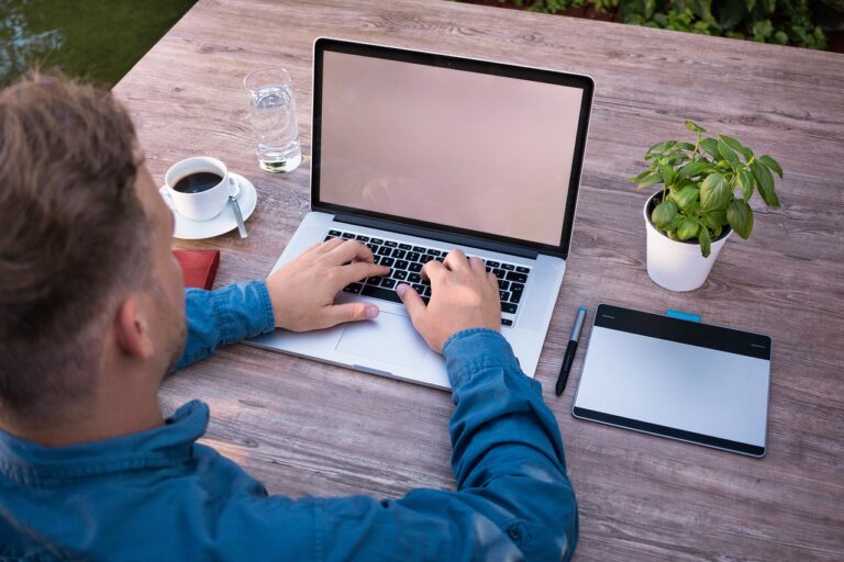 A woman works on a laptop in a modern office space