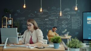 A woman presents her business idea to a panel of judges in a professional setting