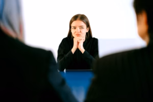 A professional woman in business attire leading a corporate team discussion