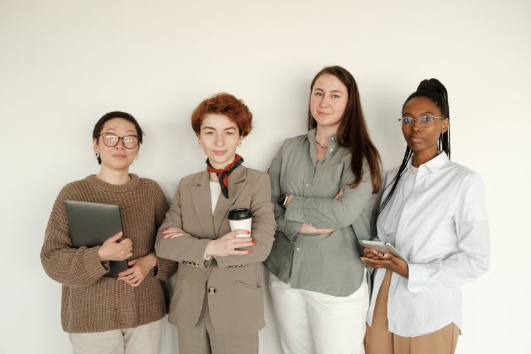 Four women standing together and facing the camera