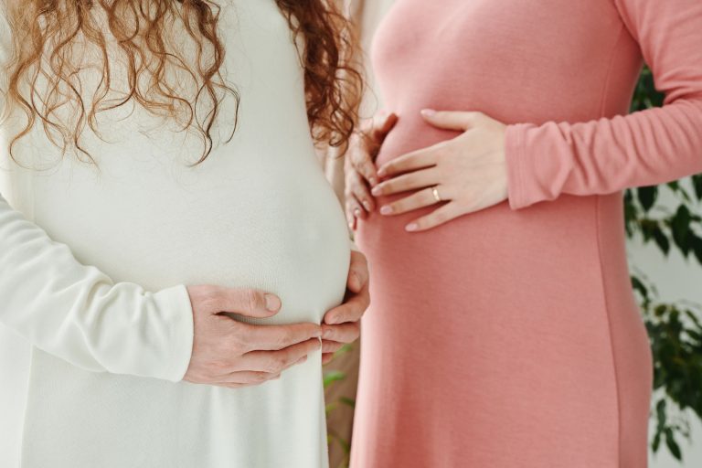 Rural Ireland Backs Abortion Leave Protections in New Survey 2 Two expectant women gently holding their pregnant bellies, symbolizing motherhood and maternity