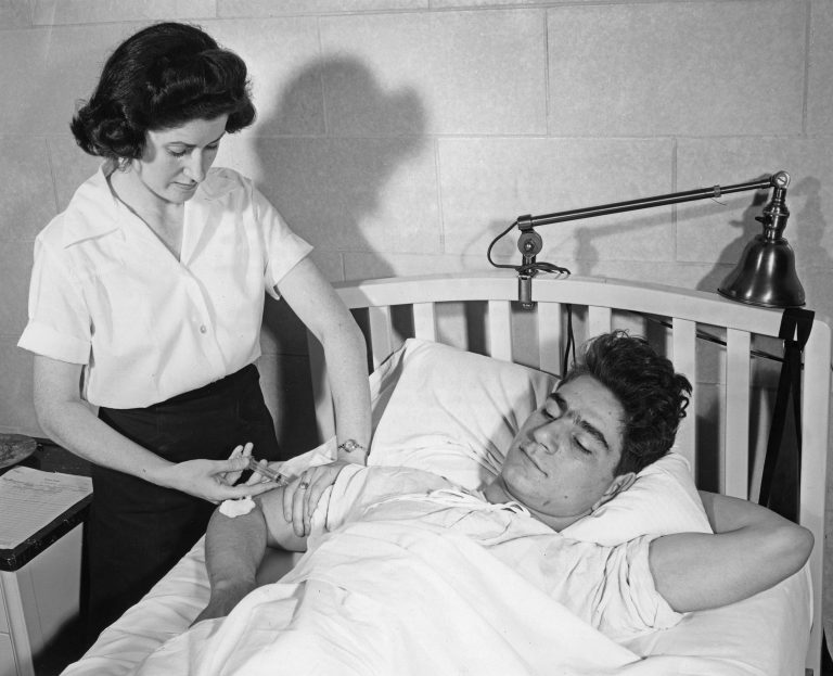 Knights Commit $1.1 Billion to Build Oregon's First Women's Hospital 1 Nurse gives injection to patient in bed