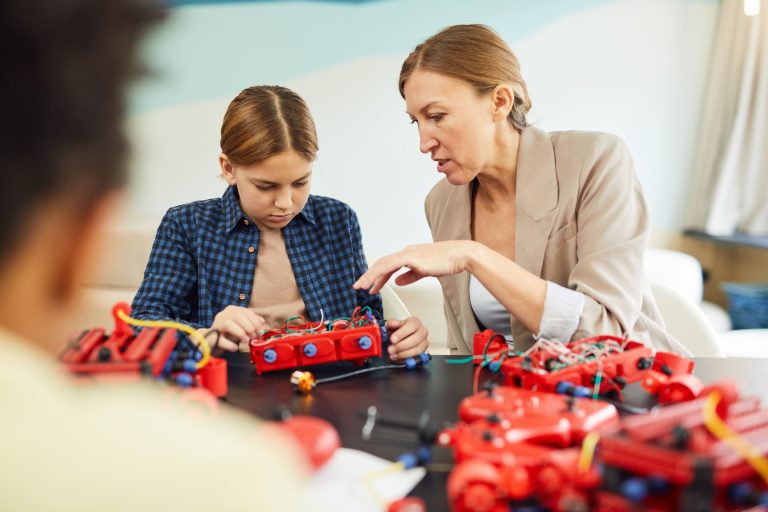 Students building a robotics kit in class