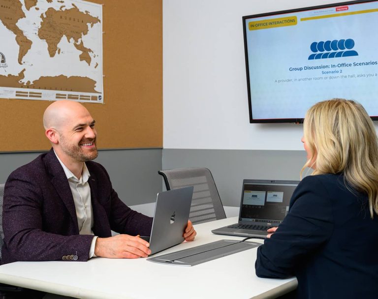 Audigy team members meeting at the company office