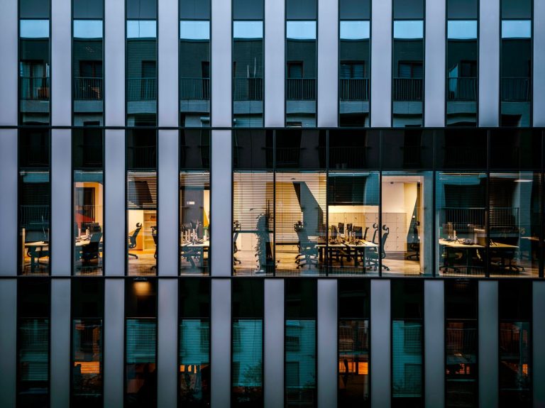 Illuminated offices seen through a glass building facade