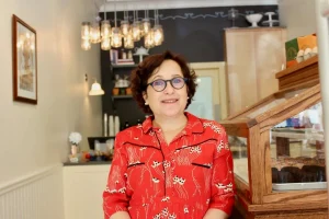 An archival portrait of Helene Godin at By the Way Bakery, separate from the September 23 event