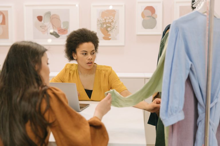 Small Business Women: Garcia, Bodine Earn County Honors 1 Stock photo of women reviewing clothing at a worktable