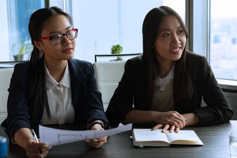 Two women engaged in a business meeting, discussing plans and ideas