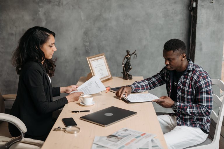 Document Bad Experiences: Irish Group Seeks 300 Women's Accounts 2 A woman and man review documents at a desk, an illustrative consultation scene