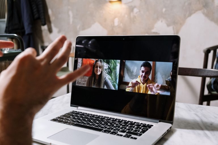 A laptop displaying two people on a video call, an illustrative remote collaboration scene