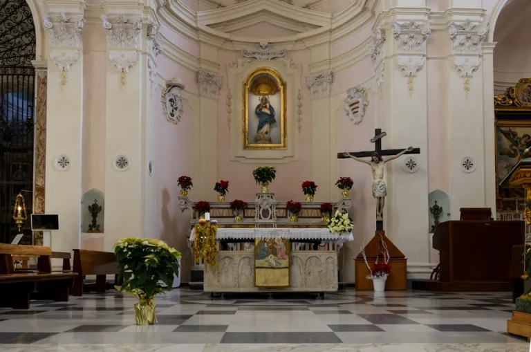 A church altar with religious statues and flowers, an illustrative stock photograph