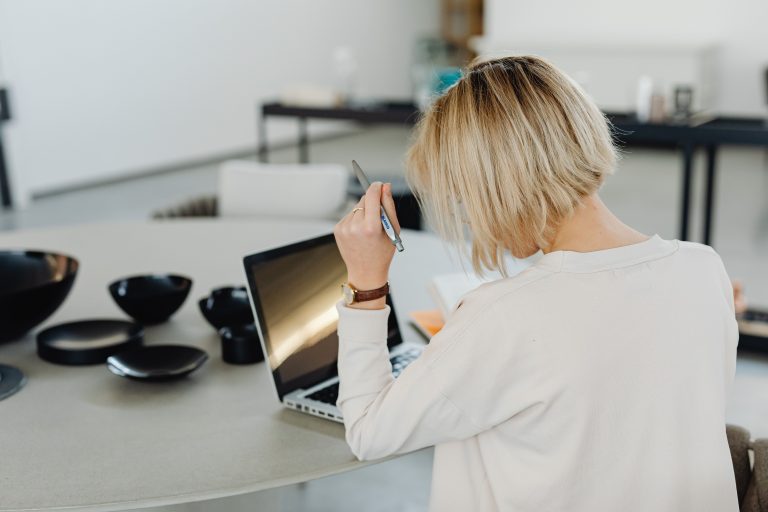 Woman working on a laptop at a desk