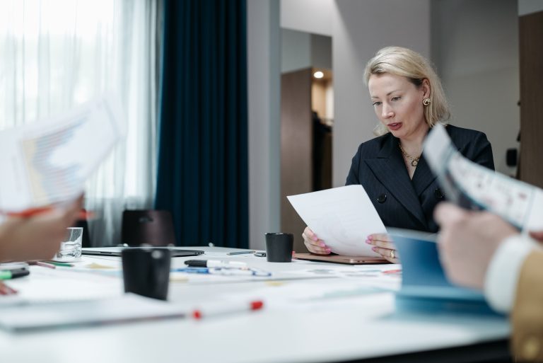 Woman reading paperwork at an office table