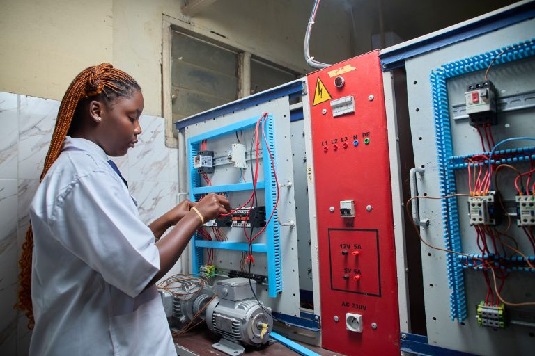 Woman working on an electrical training panel