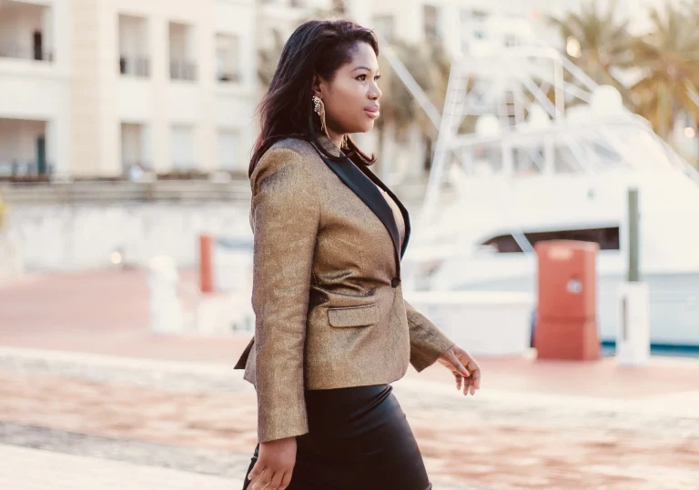 Ellen Mannaert walking outdoors in a brown blazer