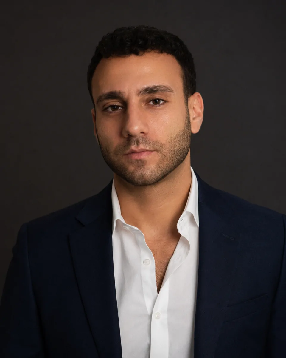 Founder 1 Portrait of Michael Peres, founder of Her Forward, in a dark blazer and white open-collar shirt