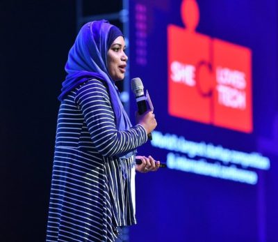 Businesswoman talking at She Loves Tech's conference