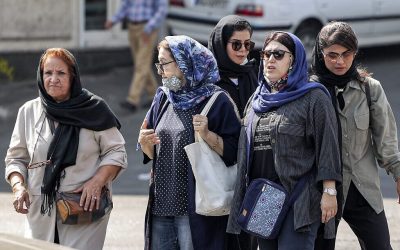 (FILES) In this file photo taken on September 26, 2022, women walk along a street in the centre of Iran's capital Tehran. - Iran's parliament and the judiciary are reviewing a law which requires women to cover their heads, and which triggered more than two months of deadly protests, the attorney general said on December 3, 2022. (Photo by ATTA KENARE / AFP)